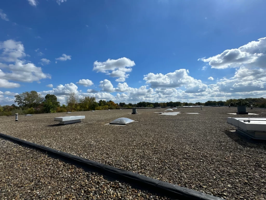 Roof inspection in Hartford showing a flat gravel-covered roof with skylights and vents.